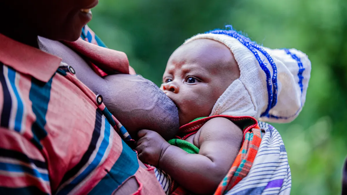 Baby nursing at a caregiver's breast
