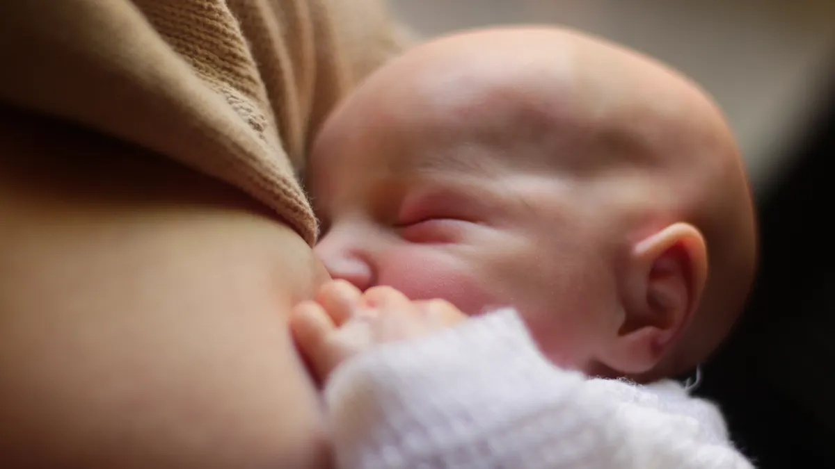 Close-up of a baby latched onto the breast