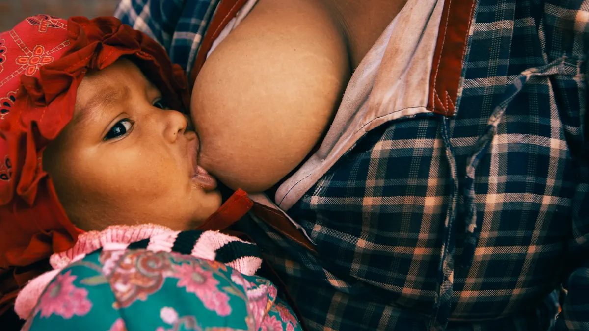 Baby breastfeeding at a breast