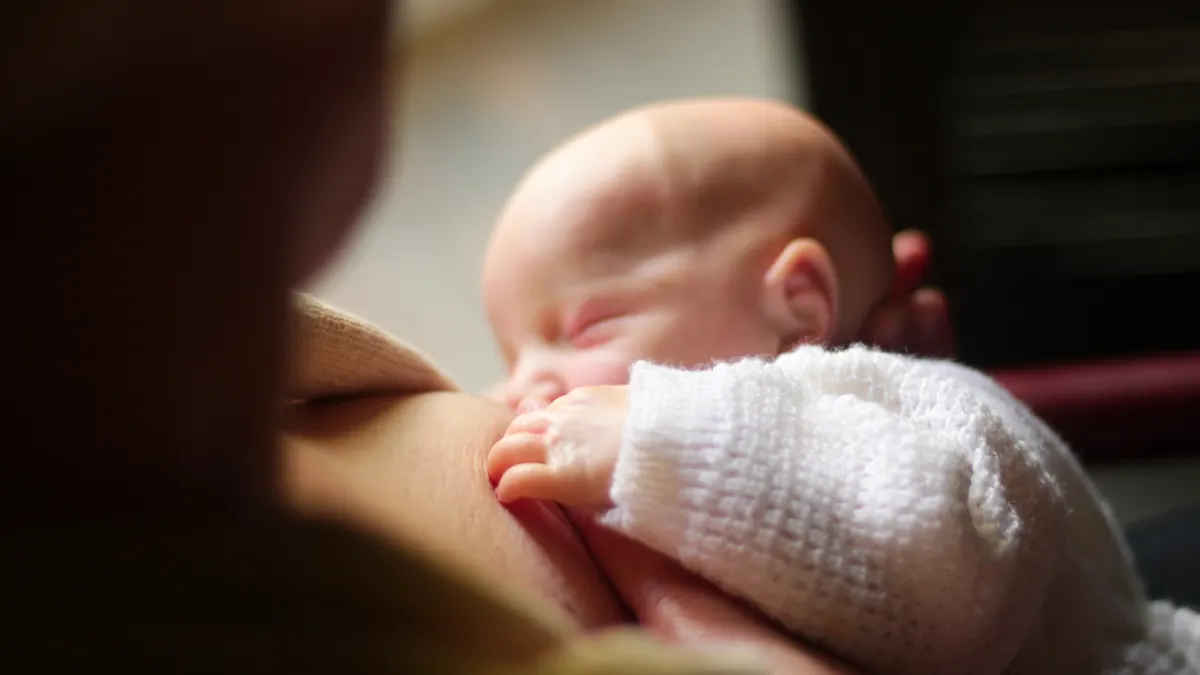 Close-up of a baby nursing at a breast