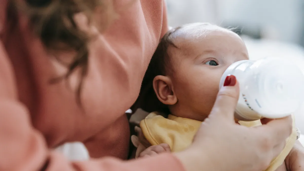 Close-up of a baby drinking from a bottle